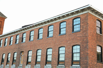 Fototapeta na wymiar brick building with arched windows, symbolizing stability and growth in the business and mortgage industry, a hub of commerce