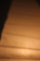 A glowing golden light background.