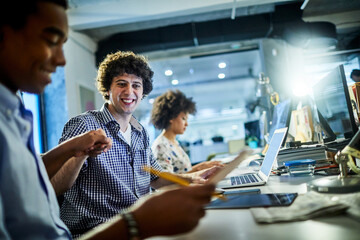 Young diverse group of coworkers sharing a moment in a modern business office