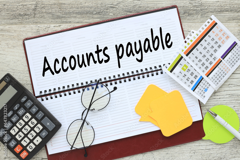 Poster accounts payable. notepad with text near calculator and calendar