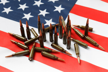 Bullets for firearms, combat army cartridges on the American flag.