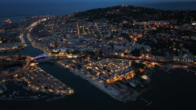 Drone captures by night: Sète's seaside allure, lively port, and maritime legacy.

