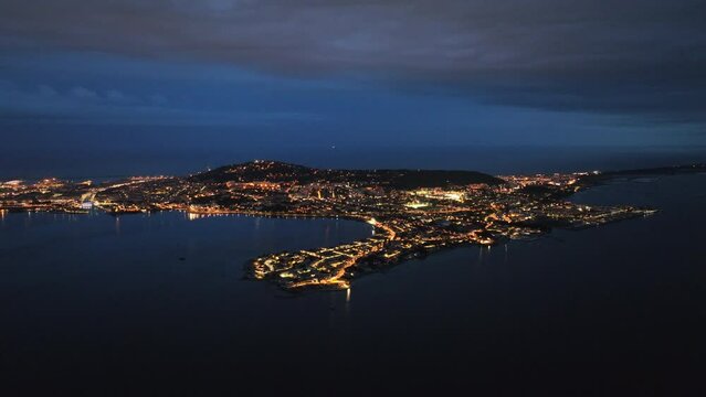 Bird's-eye night view Sète's coastal poetry, fishing industry, and maritime traditions
