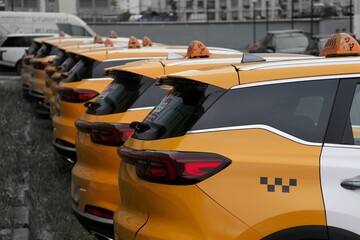 continuous rows of yellow taxi cars against the backdrop of the city 