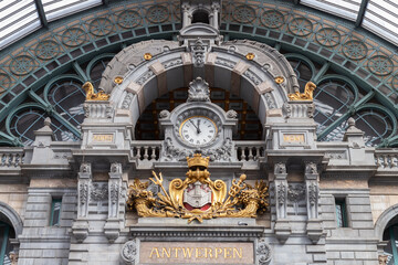 Hall with clock and sign with the Dutch city name Antwerpen in the city of Antwerp in Belgium.