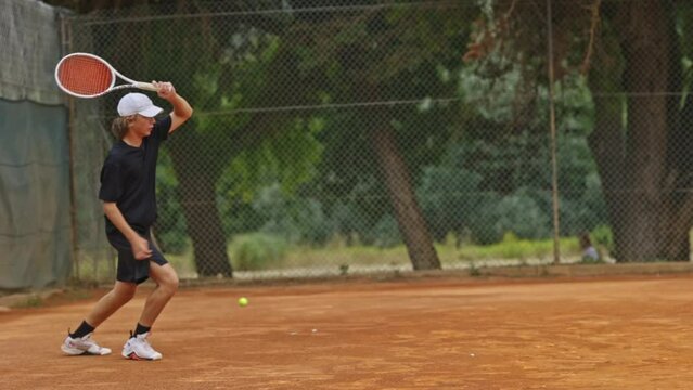 Teenager play big tennis outdoors