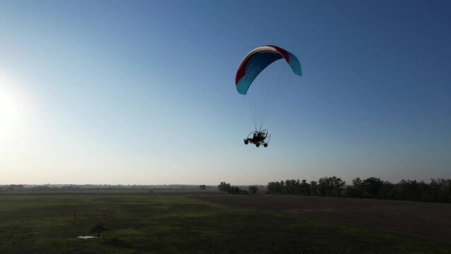 Flying close to the camera with a paramotor 