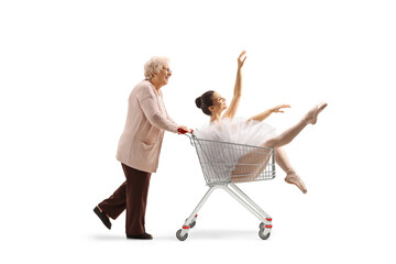 Elderly woman pushing a ballerina inside a shopping cart