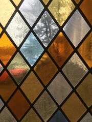 Stained glass window with diamond shapes