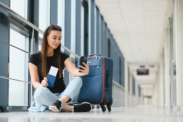 pretty woman waiting for her flight at airport
