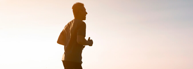 Man is training, running, warming up outdoor.