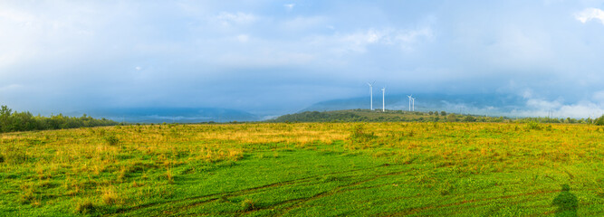 Windmills in a rural area on misty sunrise, Ukraine