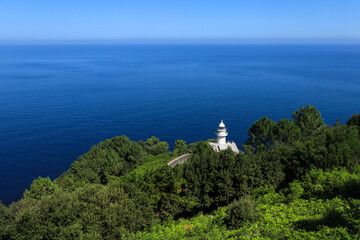Fototapeta na wymiar The Monte Igueldo lighthouse surrounded by vegetation