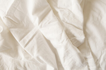White fabric background. Soft linen texture with creases and folds. 