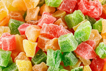 Pieces colored of candied fruits isolated on white. Multicolored dried fruit candies isolated on...