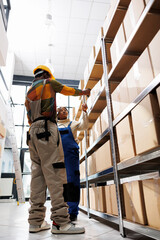 African american warehouse worker scanning parcel for logistics manager. Distribution operator...