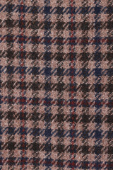 Classic tweed, Wool Background Texture. Coat close-up. Expensive suit fabric. Glenurquhart check is made of woolen fabric with a woven twill design of small and large checks.