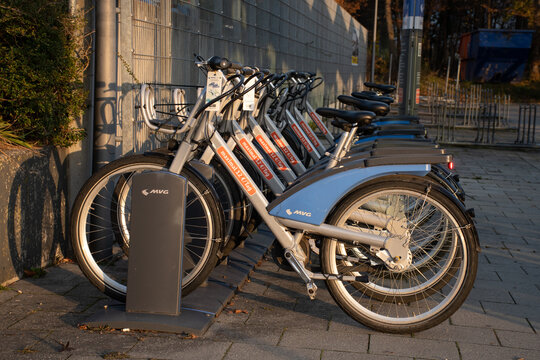 Munich, Germany - November 24, 2020: Shared bikes by MVG, a public transport operator, parked at a bike stand outside a subway station.