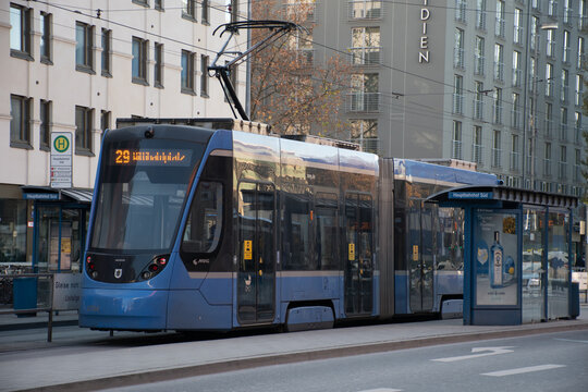 Munich, Germany - November 26, 2020: A tram at the stop outside Hauptbahnhof, the main railway station.