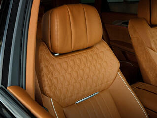 Modern luxury car brown leather interior. Part of orange perforated leather car seat details with...