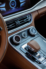 vertical photo of the Interior of premium china car, dashboard and steering wheel, screen and climate