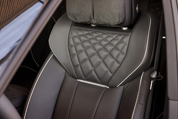 Black elegant leather electric seat with massage in the interior of a luxury car