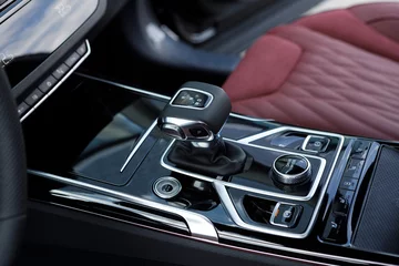 Fotobehang Automatic transmission selector with leather in the interior of a modern expensive car. Luxury car dashboard. Gear shift, car interior © AvokadoStudio