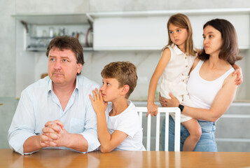 Sympathetic wife stands behind husband and gives encouragement advice to distressed husband....