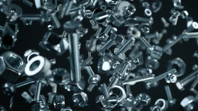 Super Slow Motion Shot of Fasteners Explosion Towards Camera Isolated on Black at 1000fps.