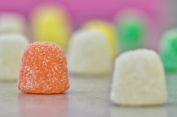 Gum Drops sugar coated candy jubes, side view macro spaced on a table with selective focus. Popular traditional gelatin based candies made worldwide.