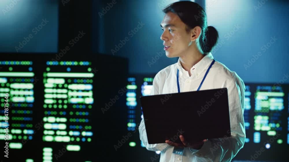Poster trained employee strolling through server rows providing processing resources for different workload