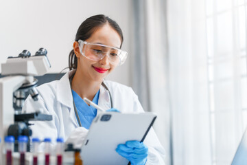 Fototapeta premium Young scientists pioneering medical discoveries in lab, with one scientist employing microscope for invaluable insights, blood lab test, virus vaccine invent, asian indian people