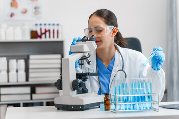 Young scientists pioneering medical discoveries in lab, with one scientist employing microscope for invaluable insights, blood lab test, virus vaccine invent, asian indian people