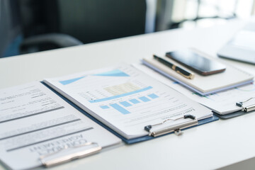 Office financial tools, close-up of calculator and financial chart on a clean desk. corporate finance workspace, uncluttered desk featuring business essentials for financial analysis.