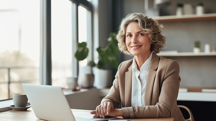 Senior businesswoman working on laptop in home office