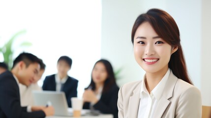 Fototapeta premium a smiling professional asian young businesswoman standing at her desk