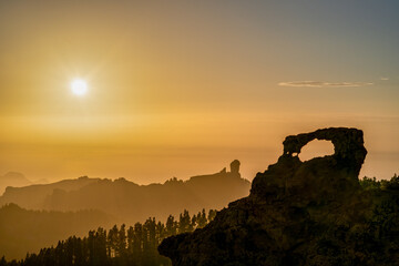 Window of Morro and Roque Nublo at the summit of Gran Canaria, sunset on a day with haze