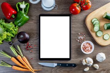 Vegetables and ingredients on wooden table background, cooking concept, top view, tablet