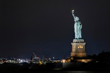A view of the Statue of Liberty as seen from the Staten Island Ferry at night.