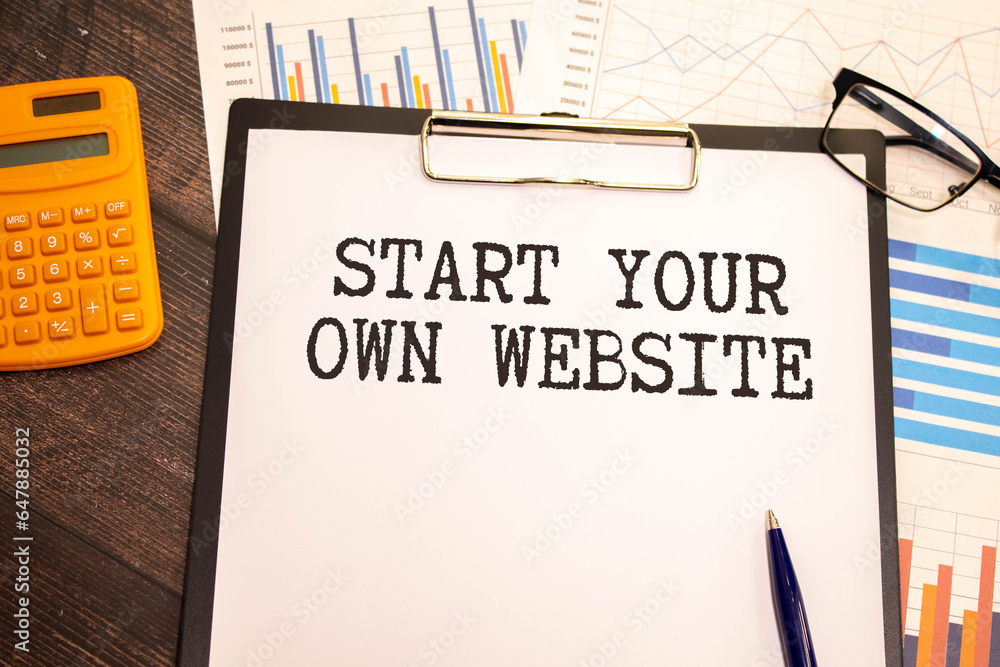 Poster notebook with text start your own website on wooden table with pen, magnifier and glasses