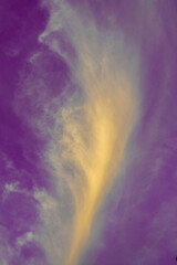 a bright pink sky with striped clouds illuminated by the orange of the afternoon sun