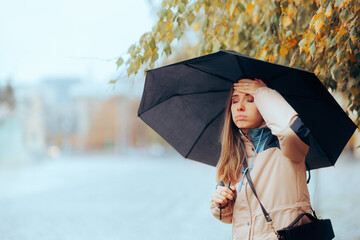 Forgetful Woman Remembering Something Important on a Rainy day. Stressed girl having an idea thinking outdoors in the rain
