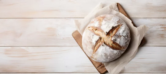 Fotobehang Bakkerij a loaf of freshly baked sourdough bread on a wooden table, banner with copy space