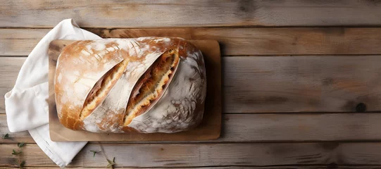 Crédence de cuisine en plexiglas Boulangerie a loaf of freshly baked sourdough bread on a wooden table, banner with copy space