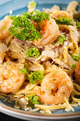 Fettuccine with shrimp and parsley - dark rustic background
