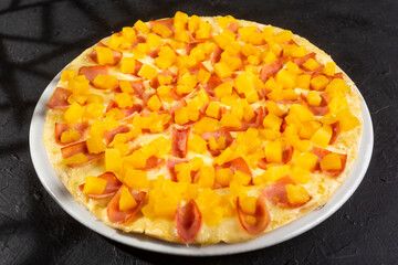 Delicious Hawaiian pizza with pineapple, ham and mozzarella