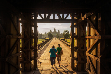 Fototapeta premium Tourists entrance going into Angkor wat temple in the morning 