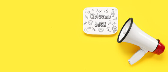 Megaphone and paper sheet with text WELCOME BACK on yellow background with space for text