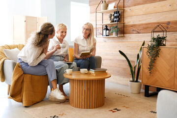 Mature women taking part in book club at home