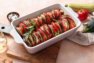 Baking dish of tasty Ratatouille on beige background